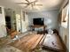 Living room with ceiling fan, light blue walls, and light-filled windows at 19109 2Nd St, Indian Shores, FL 33785