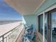 Scenic balcony with ocean views, sliding glass doors, and comfortable seating arrangement at 19440 Gulf Blvd # 301, Indian Rocks Beach, FL 33785