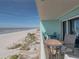 Charming balcony with outdoor seating, ideal for relaxing and enjoying panoramic beach views at 19440 Gulf Blvd # 301, Indian Rocks Beach, FL 33785