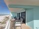 Cozy balcony featuring a table and chairs, perfect for enjoying the stunning ocean views at 19440 Gulf Blvd # 301, Indian Rocks Beach, FL 33785