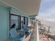 Spacious balcony overlooks sandy beach, offers ocean views, lounge chairs and more seating at 19440 Gulf Blvd # 301, Indian Rocks Beach, FL 33785