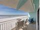 Relaxing balcony seating with stunning ocean views and white sand at 19440 Gulf Blvd # 301, Indian Rocks Beach, FL 33785