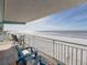 Spacious balcony overlooks sandy beach, offers ocean views, lounge chairs and more seating at 19440 Gulf Blvd # 301, Indian Rocks Beach, FL 33785