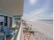 Expansive balcony with pool view, beach access, cozy seating options at 19440 Gulf Blvd # 301, Indian Rocks Beach, FL 33785