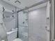 Bright bathroom features a tiled shower with glass door and a modern toilet at 19440 Gulf Blvd # 301, Indian Rocks Beach, FL 33785