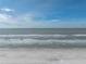 Expansive beach with clear ocean view and blue sky with light clouds at 19440 Gulf Blvd # 301, Indian Rocks Beach, FL 33785