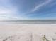 Serene beach view showcasing the ocean, shoreline, and blue sky, ideal for coastal living enthusiasts at 19440 Gulf Blvd # 301, Indian Rocks Beach, FL 33785