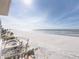 Expansive beach view from the balcony, highlighting the ocean, shoreline, and nearby pool at 19440 Gulf Blvd # 301, Indian Rocks Beach, FL 33785
