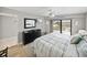 Well-lit bedroom with a queen bed, dresser, mirror, and balcony access at 19440 Gulf Blvd # 301, Indian Rocks Beach, FL 33785
