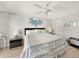 Neutral bedroom with a queen bed, ceiling fan, and coastal accents at 19440 Gulf Blvd # 301, Indian Rocks Beach, FL 33785