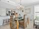 Dining area with chandelier and coastal decor open to kitchen at 19440 Gulf Blvd # 301, Indian Rocks Beach, FL 33785