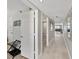 Hallway with tile flooring, a bathroom entrance, and a view of the ocean at 19440 Gulf Blvd # 301, Indian Rocks Beach, FL 33785