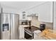 Cozy kitchen features stainless steel appliances, granite countertops, and white cabinetry at 19440 Gulf Blvd # 301, Indian Rocks Beach, FL 33785