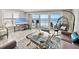 Charming living room with ocean views, stylish furniture, and sliding glass doors to the balcony at 19440 Gulf Blvd # 301, Indian Rocks Beach, FL 33785