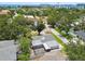 An aerial view of a charming home nestled in a lush, green neighborhood with mature trees and a screened in pool at 2 S Treasure Dr, Tampa, FL 33609