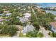 Aerial view of a single-Gathering home near a lake in a lush green residential area with waterfront views at 2 S Treasure Dr, Tampa, FL 33609