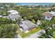 Aerial view of a single-Gathering home near a lake and close to the bay in a lush green residential area at 2 S Treasure Dr, Tampa, FL 33609