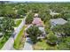 Aerial view of a quaint single-Gathering home with lush green trees in a charming residential neighborhood at 2 S Treasure Dr, Tampa, FL 33609