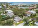 Aerial view of a single-Gathering home near a lake and close to the bay in a lush green residential area at 2 S Treasure Dr, Tampa, FL 33609