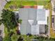 Aerial view of the home's roof and yard, showing landscaping, patio, walkway, and proximity to trees at 2 S Treasure Dr, Tampa, FL 33609