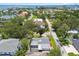 Aerial view of a single-Gathering home with screened-in patio near lush tropical landscaping and distant bay views at 2 S Treasure Dr, Tampa, FL 33609