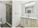 Bathroom featuring a glass-enclosed shower with marble tiling and a modern vanity at 2 S Treasure Dr, Tampa, FL 33609