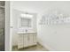 Bright bathroom with a vanity with marble countertop and an LED-illuminated mirror at 2 S Treasure Dr, Tampa, FL 33609