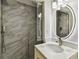 Modern bathroom featuring a glass shower with stone tiling and an LED-illuminated mirror at 2 S Treasure Dr, Tampa, FL 33609