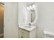 Modern bathroom boasts a round LED mirror over a vanity with granite counter and cabinet at 2 S Treasure Dr, Tampa, FL 33609