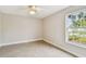 Bedroom with tile floors, a ceiling fan, and a window that provides ample natural light at 2 S Treasure Dr, Tampa, FL 33609