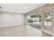 Bright bonus room with large windows offering views of the screened patio, complete with sleek, wood-look flooring at 2 S Treasure Dr, Tampa, FL 33609
