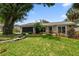 Charming single-story home featuring a well-manicured lawn and lush landscaping at 2 S Treasure Dr, Tampa, FL 33609