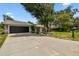 Charming single-story home featuring a well-manicured lawn and lush landscaping at 2 S Treasure Dr, Tampa, FL 33609