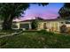 Charming single-story home featuring a well-manicured lawn and lush landscaping at 2 S Treasure Dr, Tampa, FL 33609