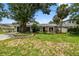 Charming single-story home featuring a well-manicured lawn and lush landscaping at 2 S Treasure Dr, Tampa, FL 33609