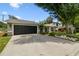 Charming single-story home featuring a well-manicured lawn and lush landscaping at 2 S Treasure Dr, Tampa, FL 33609