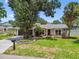 Charming home with mature trees, manicured lawn, and welcoming front porch at 2 S Treasure Dr, Tampa, FL 33609