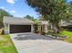 Charming home featuring a spacious driveway, well-manicured lawn and lush landscaping at 2 S Treasure Dr, Tampa, FL 33609