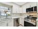 Close-up of a bright kitchen with stainless steel appliances and a modern tile backsplash for added style at 2 S Treasure Dr, Tampa, FL 33609