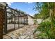 Enclosed lanai with stone pathway and lush landscaping offers a private outdoor retreat at 2 S Treasure Dr, Tampa, FL 33609