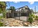 Enclosed lanai with stone pathway and lush landscaping offers a private outdoor retreat at 2 S Treasure Dr, Tampa, FL 33609