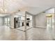 Open-concept living area with modern appliances, stainless steel refrigerator and herringbone backsplash at 2 S Treasure Dr, Tampa, FL 33609