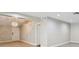 Neutral living room featuring a modern chandelier, wood-look tile floors, and an open transition to the adjacent room at 2 S Treasure Dr, Tampa, FL 33609