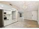 Open-concept living room featuring a modern chandelier and seamless flow into the adjacent kitchen area at 2 S Treasure Dr, Tampa, FL 33609