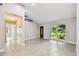 Open-concept living room featuring bright, natural light and gray tile flooring throughout the main living space at 2 S Treasure Dr, Tampa, FL 33609