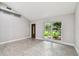 Bright living room featuring vaulted ceilings and light gray wood-look tile floors at 2 S Treasure Dr, Tampa, FL 33609