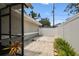 View of the side yard of the property with pavers and privacy fence at 2 S Treasure Dr, Tampa, FL 33609