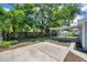 Spacious backyard with covered patio, concrete pads and mature trees offers space for outdoor enjoyment at 2509 W Crawford St, Tampa, FL 33614