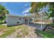 Wide shot of backyard featuring a covered patio and well-maintained green space at 2509 W Crawford St, Tampa, FL 33614