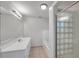Modern bathroom with a bright vanity, shower-tub combo, and neutral floor tiles at 2509 W Crawford St, Tampa, FL 33614